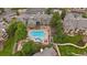Aerial view of a beautiful community pool surrounded by lounge chairs and lush landscaping at 7413 S Quail Cir # 1435, Littleton, CO 80127