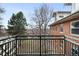 A charming balcony with views of the exterior of the apartment, including the trees and lawn below at 3249 W Fairview Pl # 207, Denver, CO 80211