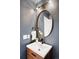 Chic powder room with modern fixtures, a round mirror, and stylish vanity at 3249 W Fairview Pl # 207, Denver, CO 80211