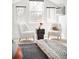 Bright bedroom features cozy seating, three large windows and charming decor at 3249 W Fairview Pl # 207, Denver, CO 80211