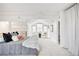 Serene bedroom with vaulted ceilings, ample natural light, and cozy seating area at 3249 W Fairview Pl # 207, Denver, CO 80211