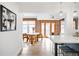 Dining area with modern table, chairs, and exposed brick wall with natural light at 3249 W Fairview Pl # 207, Denver, CO 80211
