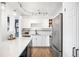 Bright kitchen featuring white cabinetry, stainless steel appliances, and modern track lighting at 3249 W Fairview Pl # 207, Denver, CO 80211