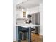 Stylish kitchen with stainless steel appliances, white cabinetry, and eat-in bar area at 3249 W Fairview Pl # 207, Denver, CO 80211