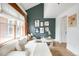 Bright living room featuring a modern sofa, large windows, and stylish decor against an accent wall at 3249 W Fairview Pl # 207, Denver, CO 80211