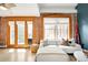 Bright living room boasts exposed brick, hardwood floors, and stylish furnishings at 3249 W Fairview Pl # 207, Denver, CO 80211