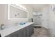 Modern bathroom featuring double sink vanity and a glass-enclosed shower with sleek design at 19205 Sixpenny Ln, Monument, CO 80132