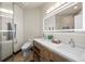 Modern bathroom with a double vanity, sleek fixtures, and a glass-enclosed shower for a spa-like experience at 19205 Sixpenny Ln, Monument, CO 80132