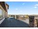 Spacious deck area with stone accents, dark floors, and incredible scenic views at 19205 Sixpenny Ln, Monument, CO 80132