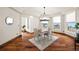 Bright dining room with wood floors, modern lighting, and large windows with neighborhood views at 19205 Sixpenny Ln, Monument, CO 80132