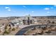 Expansive estate featuring a circular driveway and manicured landscaping against a scenic backdrop at 19205 Sixpenny Ln, Monument, CO 80132