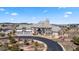 Elegant home featuring stone and siding exterior, a three-car garage, and beautiful landscaping on a sunny day at 19205 Sixpenny Ln, Monument, CO 80132
