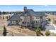 Elegant home exterior with multi-level deck offering stunning views of the mountains and landscape at 19205 Sixpenny Ln, Monument, CO 80132