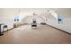 Expansive game room with high ceilings, an air hockey table, and natural light from large windows at 19205 Sixpenny Ln, Monument, CO 80132