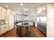 Spacious kitchen featuring a custom island, stainless steel appliances, custom cabinets, and great natural light at 19205 Sixpenny Ln, Monument, CO 80132