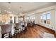 Spacious kitchen with hardwood floors, a large island with bar seating, and oversized picture windows at 19205 Sixpenny Ln, Monument, CO 80132