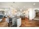 Open-concept kitchen featuring a breakfast bar, custom cabinets, and connection to the living area at 19205 Sixpenny Ln, Monument, CO 80132