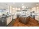 View of the kitchen showing the kitchen island, sink, stainless appliances, and custom cabinets at 19205 Sixpenny Ln, Monument, CO 80132