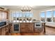 View of the hardwood kitchen island featuring seating, plentiful cabinet storage and lovely views at 19205 Sixpenny Ln, Monument, CO 80132