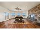 Spacious living room featuring a stone fireplace and a view of the landscape at 19205 Sixpenny Ln, Monument, CO 80132