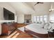 Spacious main bedroom with a stone fireplace, a sitting area and large windows with neighborhood views at 19205 Sixpenny Ln, Monument, CO 80132