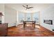 Cozy sitting room with a stone accent wall, hardwood floors, and large windows with neighborhood views at 19205 Sixpenny Ln, Monument, CO 80132