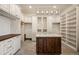 Expansive walk-in closet with custom shelving, hanging rods, and a central island for organization at 19205 Sixpenny Ln, Monument, CO 80132