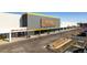 Commercial building featuring a modern facade, ample parking, and a variety of businesses, ideal for retail or office space at 9061 E 14Th St, Aurora, CO 80010