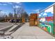 Unique commercial building with natural wood siding, mural, and sidewalk, perfect for business seeking artistic facade at 9061 E 14Th St, Aurora, CO 80010