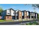 Contemporary townhome complex with brick and modern siding, showcasing a well-maintained landscape at 9061 E 14Th St, Aurora, CO 80010