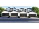 A row of modern townhomes features sleek black garage doors, presenting a clean and contemporary exterior at 9061 E 14Th St, Aurora, CO 80010