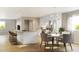 Bright, open kitchen featuring modern appliances, a large island, and an adjacent dining area at 9061 E 14Th St, Aurora, CO 80010