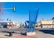 A large blue chair stands as public art along a street, near local shops and traffic lights at 9061 E 14Th St, Aurora, CO 80010