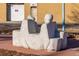 A concrete sculpture of people sitting back to back provides a unique public art feature in an urban setting at 9061 E 14Th St, Aurora, CO 80010