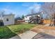 Spacious backyard with a storage shed, deck, and grassy area, ideal for outdoor activities at 19792 E Bates Dr, Aurora, CO 80013