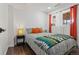 Bedroom featuring a bed, wood floors, and two windows with coverings at 19792 E Bates Dr, Aurora, CO 80013