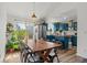 Bright dining area with wood table, stylish seating, and views of the backyard and the kitchen at 19792 E Bates Dr, Aurora, CO 80013