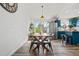Charming dining area with wooden table and chairs, complemented by natural light and modern décor at 19792 E Bates Dr, Aurora, CO 80013