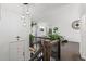 Inviting entryway with wooden staircase, modern lighting, and bright, open floor plan at 19792 E Bates Dr, Aurora, CO 80013