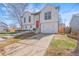 Stylish two-story home with a white exterior, driveway, and manicured lawn at 19792 E Bates Dr, Aurora, CO 80013