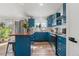 Modern kitchen featuring blue cabinets, stainless steel appliances, and hardwood floors at 19792 E Bates Dr, Aurora, CO 80013