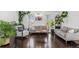 Cozy living room featuring hardwood floors, stylish decor, and plenty of natural light at 19792 E Bates Dr, Aurora, CO 80013