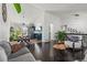 Open-concept living space with hardwood floors and seamless flow to the dining area at 19792 E Bates Dr, Aurora, CO 80013