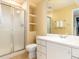 Well-lit bathroom featuring a shower, vanity, and built-in shelving at 2552 E Alameda Ave # 16, Denver, CO 80209