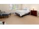 Carpeted bedroom featuring a twin bed, window, dresser, and sitting chair at 2552 E Alameda Ave # 16, Denver, CO 80209