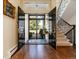Grand entryway featuring hardwood floors, a staircase, and double doors leading to the home's exterior at 2552 E Alameda Ave # 16, Denver, CO 80209