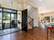 Inviting entryway with hardwood floors, stairs, and natural light streaming through the front door and sidelight windows at 2552 E Alameda Ave # 16, Denver, CO 80209