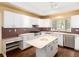 Bright kitchen with modern appliances, white cabinets, and a functional center island at 2552 E Alameda Ave # 16, Denver, CO 80209