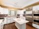 Well-equipped kitchen featuring stainless steel appliances, white cabinets, and center island at 2552 E Alameda Ave # 16, Denver, CO 80209