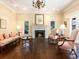 Cozy living room features a fireplace, hardwood floors, large windows, and a chandelier at 2552 E Alameda Ave # 16, Denver, CO 80209